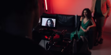 Behind the scenes of a studio filming session focused on actors within a creative setup.