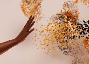 Creative concept depicting a hand reaching towards abstract swirling particles.