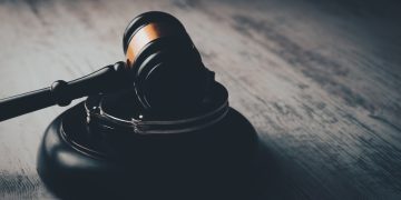 a judge's gaven on a wooden table