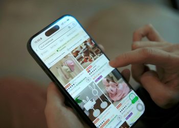 Person browsing shopping app on smartphone, displaying modern ecommerce interface.