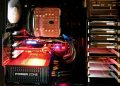 Close-up of a custom gaming PC with RGB lighting, showcasing power supply and components.