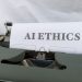 Close-up of vintage typewriter with 'AI ETHICS' typed on paper, emphasizing technology and responsibility.