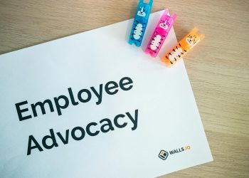 Colorful office stationery featuring quirky clips and 'Employee Advocacy' sign on a desk.