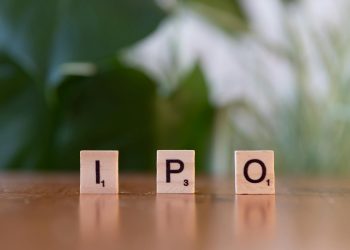 Wooden letter blocks spelling IPO on a table, symbolizing investment opportunities.