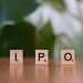 Wooden letter blocks spelling IPO on a table, symbolizing investment opportunities.