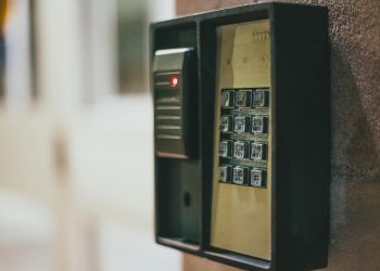 Close-up of a security access control keypad with illuminated buttons for keyless entry.