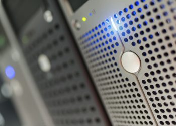 Focused detail of a modern server rack with blue LED indicators in a data center.