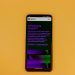 Smartphone displaying ChatGPT interface on a vibrant background, showcasing AI technology.