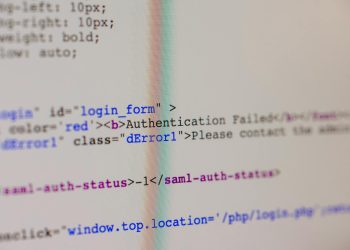 Close-up of HTML and PHP code on screen showing error message and login form data.