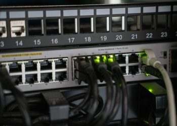 Networking equipment with connected cables, showcasing modern technology infrastructure.