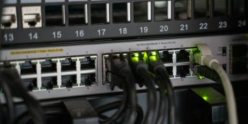 Networking equipment with connected cables, showcasing modern technology infrastructure.