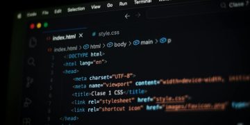 Close-up of HTML code displayed on a computer screen in dark mode, focusing on programming concepts.