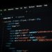 Close-up of HTML code displayed on a computer screen in dark mode, focusing on programming concepts.