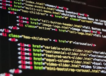 Close-up of HTML code highlighted in vibrant colors on a computer monitor.