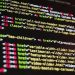 Close-up of HTML code highlighted in vibrant colors on a computer monitor.