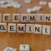 Wooden Scrabble tiles spelling 'Deepmind' and 'Gemini' on a wooden surface, a concept of AI and games.