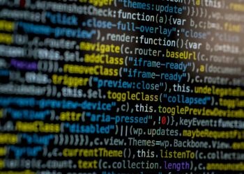 An extreme close-up of colorful programming code on a computer screen, showcasing development and software debugging.