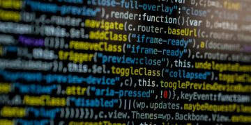 An extreme close-up of colorful programming code on a computer screen, showcasing development and software debugging.