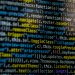 An extreme close-up of colorful programming code on a computer screen, showcasing development and software debugging.