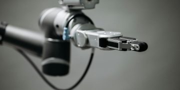 Close-up of a robotic arm showcasing advanced technology and innovation in an indoor environment.