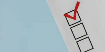 A simple white paper checklist with one red checkmark, ideal for concepts like completion or approval.