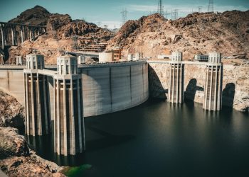 A majestic view of Hoover Dam against a desert landscape, showcasing American engineering