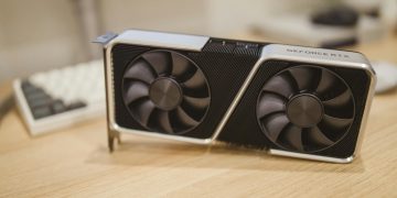 Close-up of a GeForce RTX graphics card on a desk, showcasing its design and technology.