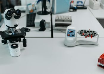 A well-equipped laboratory with a microscope and vials ready for analysis.