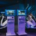 Futuristic gaming chairs with VR headsets and monitors, capturing immersive gameplay in a modern arcade.