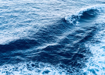 A captivating view of dynamic ocean waves with foam, showcasing the beauty of the sea.