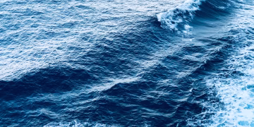 A captivating view of dynamic ocean waves with foam, showcasing the beauty of the sea.
