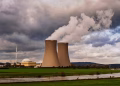 Scenic view of a nuclear power plant with cooling towers emitting steam in Hameln, Germany.