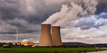 Scenic view of a nuclear power plant with cooling towers emitting steam in Hameln, Germany.