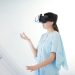 Young woman engaged in virtual reality experience with a headset indoors.