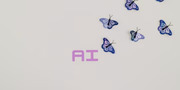 A creative image of butterflies flying over the word 'AI' on a soft pastel background, symbolizing innovation.