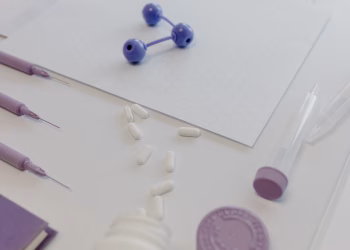 Medical tools and pills arranged on a table, showcasing a laboratory research setting.