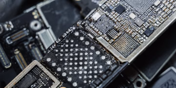 Detailed macro shot of electronic microchip components on a circuit board.