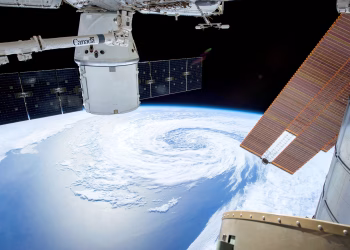 A mesmerizing view of Earth as seen from a space station with solar panels and satellite modules.