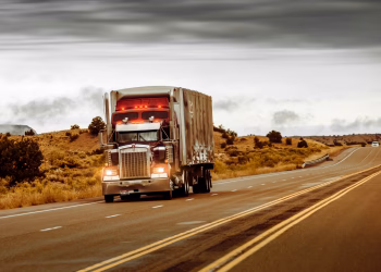A large truck driving on a desert highway in Nevada, USA. Perfect for transportation themes.