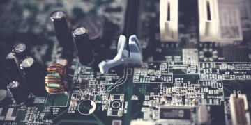 Detailed view of components on a computer motherboard, showcasing technology and circuitry.