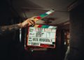 A person holding a clapper in their hand