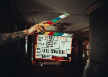 A person holding a clapper in their hand