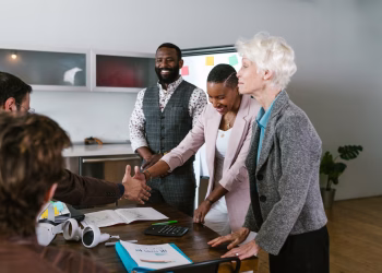 A group of diverse professionals engaged in a collaborative business meeting indoors.