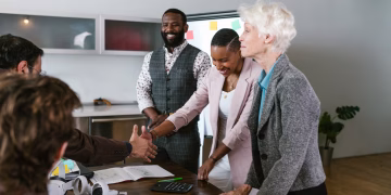 A group of diverse professionals engaged in a collaborative business meeting indoors.