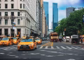 Yellow taxis and bustling traffic on a vibrant New York City street.