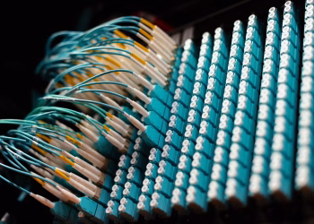 From below of long thin identical blue cables connected to small round electrical connectors