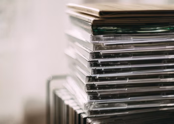 A stack of transparent CD cases neatly aligned, creating a still life composition.