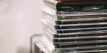 A stack of transparent CD cases neatly aligned, creating a still life composition.