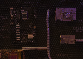 A close-up view of a motherboard and electronic components against a detailed chalkboard backdrop.