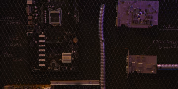 A close-up view of a motherboard and electronic components against a detailed chalkboard backdrop.